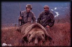 Jim Hartman of Prior Lake, MN poses over a nice brown bear with guide Braun Kopsack