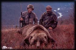 Jim Hartman of Prior Lake, MN poses over a nice brown bear with guide Braun Kopsack